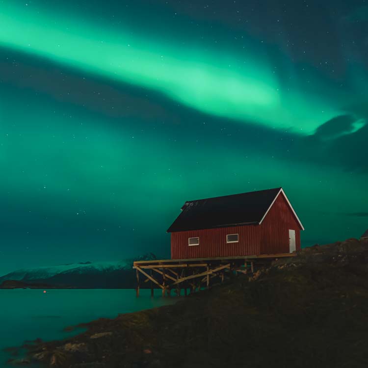 Fishermans cabin under Northern lights at Sommarøy Tromsø Norway